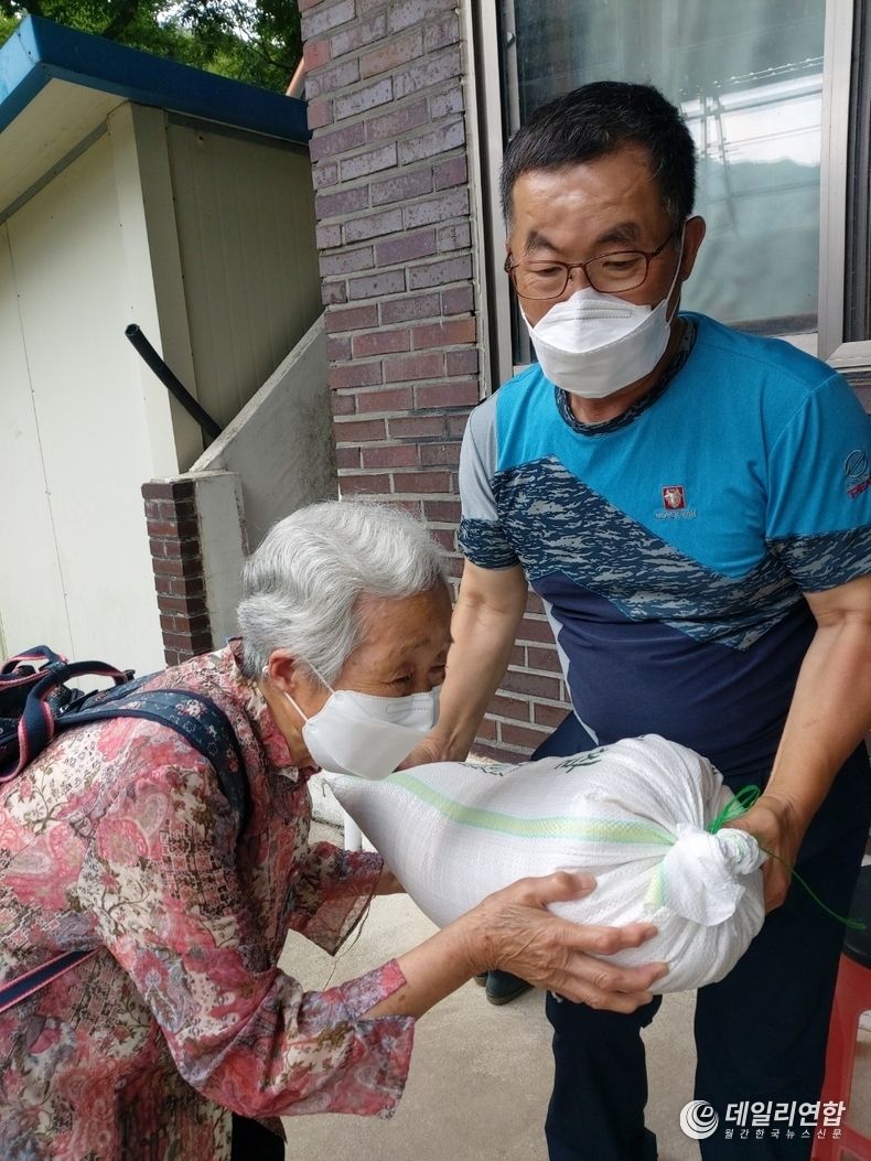 완주군 동상면 지역사회보장협의체 위원이 쌀을 전달하고 있다.(사진=완주군청)