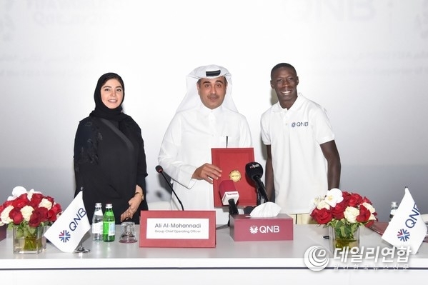 Internet sensation Khabane "Khaby" Lame, the world’s most followed person on TikTok, is pictured at the official signing ceremony with Ali Rashid Al-Mohannadi, QNB Group Executive General Manager & Group Chief Operating Officer, and Heba Ali Al-Tamimi, QNB Group General Manager Group Communications
