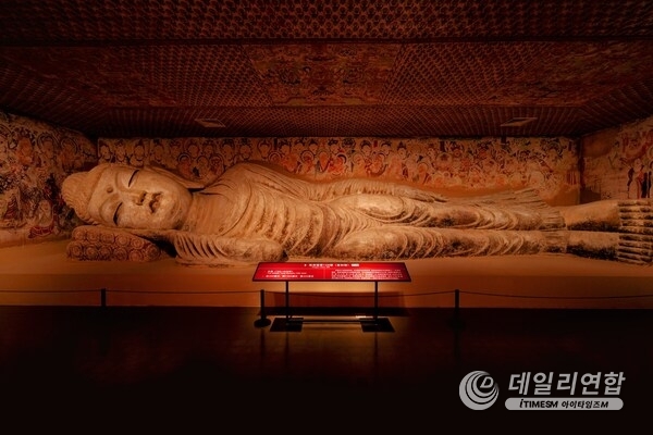 Cave 158, a renowned Nirvana cave in the Mogao Caves, features a 15.8-meter-long Buddha statue with a serene expression and a slight smile.